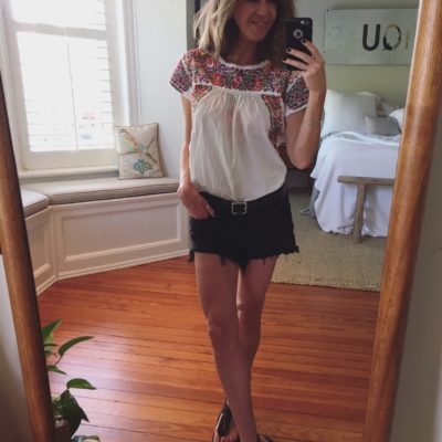 Behind the low stone wall.